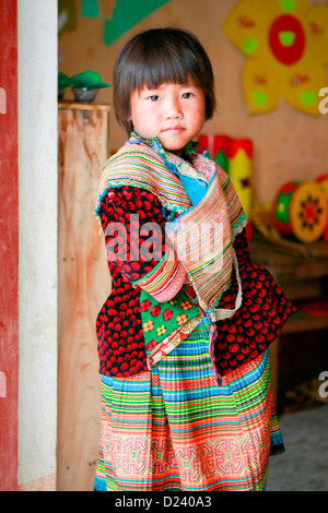 A young Flower H'mong girl at a village school near Bac Ha, North Vietnam, South East Asia. Stock Photo