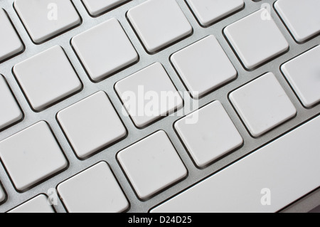 Close up image of a modern stylish aluminium white computer keyboard with blank keys for your own idea. Stock Photo