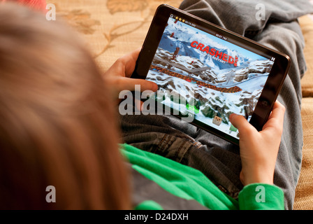 young male boy using ipad mini tablet computer Stock Photo