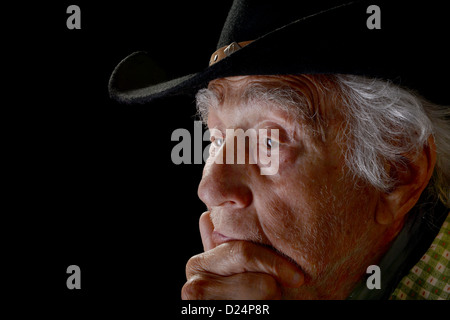Close-up on a old cowboy face with a grizzled, gray beard and weathered ...