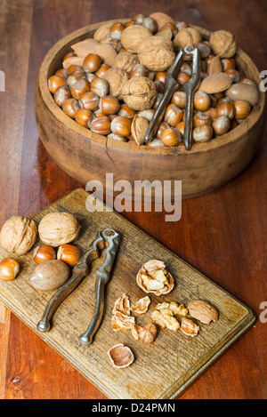 Edible nuts and nutcrackers on a table at home in a christmas setting; UK Stock Photo