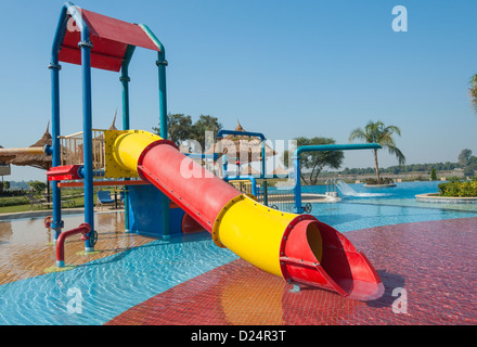 Climbing frame and slide in children's play area of a shallow swimming pool Stock Photo