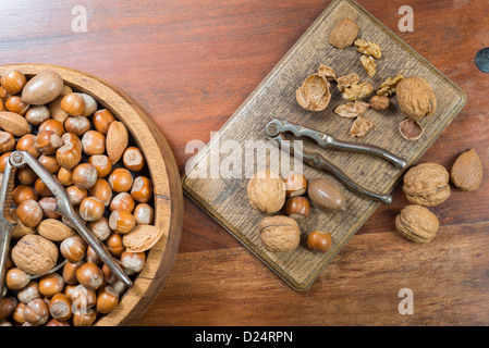 Edible nuts and nutcrackers on a table at home in a christmas setting; UK Stock Photo