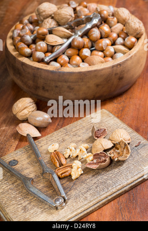 Edible nuts and nutcrackers on a table at home in a christmas setting; UK Stock Photo