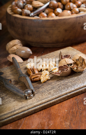 Edible nuts and nutcrackers on a table at home in a christmas setting; UK Stock Photo