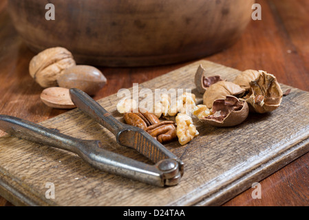 Edible nuts and nutcrackers on a table at home in a christmas setting; UK Stock Photo