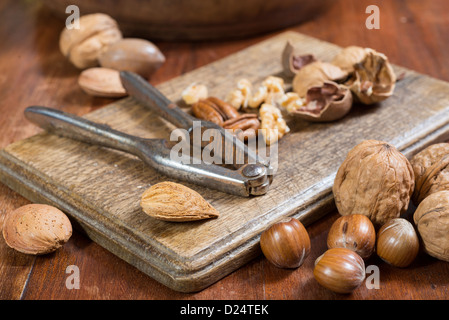 Edible nuts and nutcrackers on a table at home in a christmas setting; UK Stock Photo