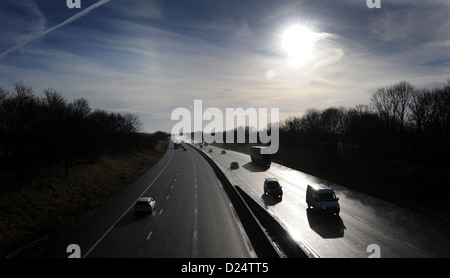 SILHOUETTED TRAFFIC ON THE M6 MOTORWAY NEAR STAFFORD RE JAMS QUEUES MOTORISTS CARS TRANSPORT LINKS LORRIES HGVS TRAVEL ROADS UK Stock Photo