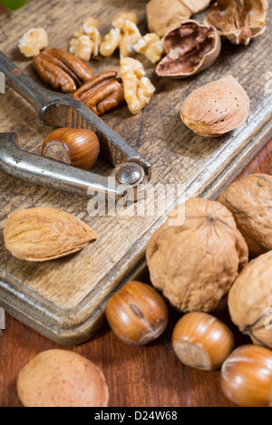 Edible nuts and nutcrackers on a table at home in a christmas setting; UK Stock Photo