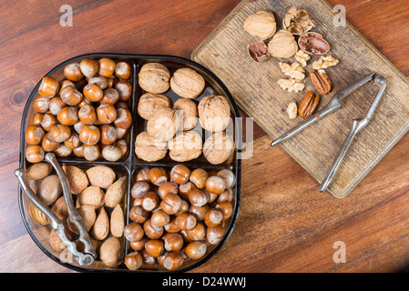 Edible nuts and nutcrackers on a table at home in a christmas setting; UK Stock Photo