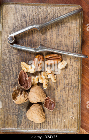 Edible nuts and nutcrackers on a table at home in a christmas setting; UK Stock Photo