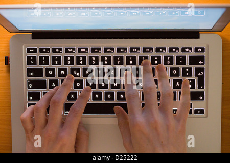 Person is working with a laptop computer. Typing on a keyboard. Stock Photo