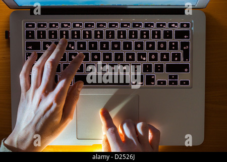 Person is working with a laptop computer. Typing on a keyboard. Stock Photo