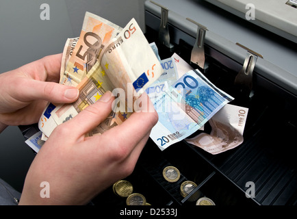 Berlin, Germany, the money in the cash register is counted Stock Photo