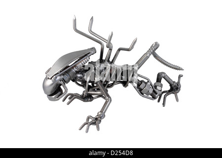 Alien sculpture made from from screws, nails, nuts, bolts and a spark plug isolated on white background Stock Photo