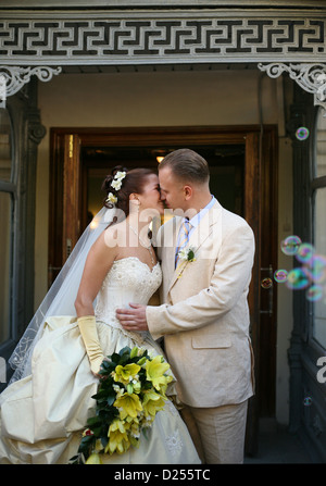 Happy newly-married couple on a background a door Stock Photo