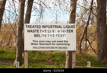 A notice warning of industrial liquid pollution in the Waimakariri river, Christchurch, Canterbury, South Island, New Zealand Stock Photo