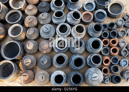 Hand made Indian water pots and money pots drying in the sun before firing. Puttaparthi, Andhra Pradesh , india Stock Photo