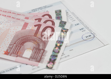 bills to pay with some banknotes over it Stock Photo