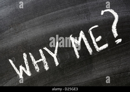 Why me? Question handwritten on school blackboard Stock Photo