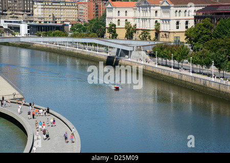 Boat at Nervión river (Bilbao, Spain) in front of the Guggenheim Bilbao museum Stock Photo