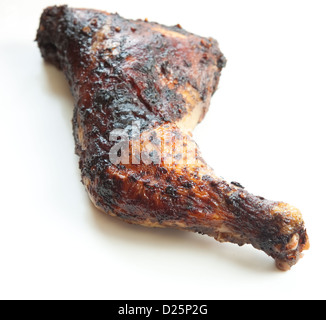 Barbecued chicken leg also known as Jerk Chicken - Caribbean style. Shallow DOF. Stock Photo