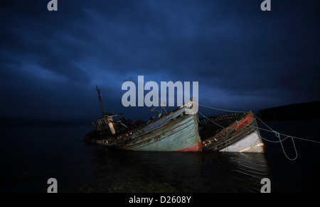 Abandoned fishing boats photographed at dusk, Salen, Isle of Mull, Scotland. Stock Photo