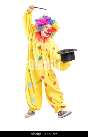 Full length portrait of a circus clown performing a magic trick isolated against white background Stock Photo