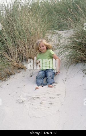 Amrum, Wittduen, Germany, 5-year-old girl playing in the dunes Stock Photo