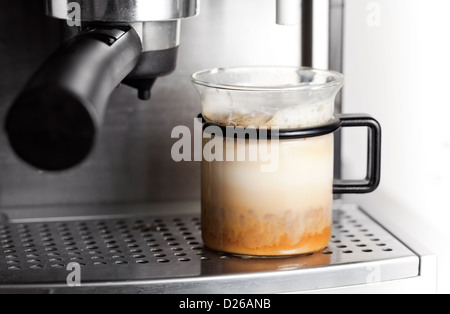 Modern glass of black coffee in espresso machine Stock Photo