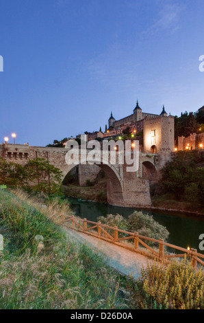 Europe, Spain, Toledo, Alcantara Bridge (Puente de Alcantars) over the Tagus River with Alcazar Fortress in the Background