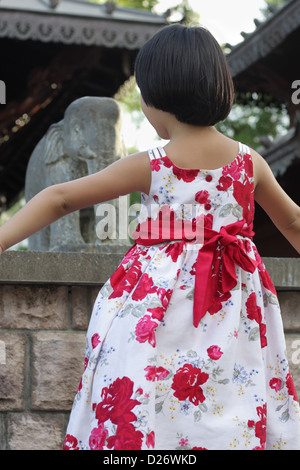 Beautiful Asian Girl with Fuchsia Dress in front of Temple Stock Photo