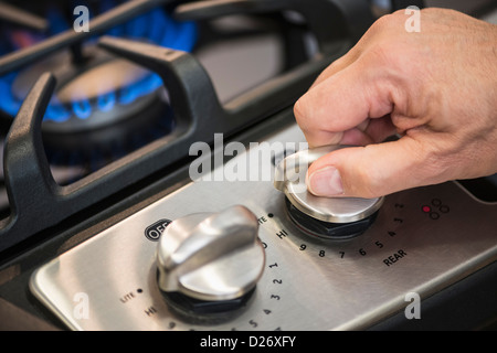 USA, New Jersey, Jersey City, Close-up of hand adjusting stove burner Stock Photo