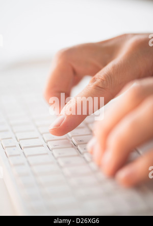 Close-up of hands typing on keyboard Stock Photo