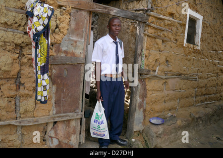 KENYA Scenes in the slum of Bangladesh. Alex Odhiambo setting off for school. Mombasa. photo by Sean Sprague Stock Photo