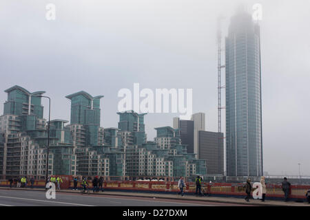 London, UK. 16th January 2013. Aftermath of a helicopter crash into the crane constructing the residential skyscraper St George's Wharf  Tower at Vauxhall in south London. At approximately 08.00 the aircraft apparently crashed into the crane in freezing fog, landing in the road next to a mainline railway line. The tower is 181 metres (594 ft) tall with 49 storeys, now the tallest residential building in the United Kingdom. Its crane that operated on the side of the tower was torn away, landing below.  Credit:  RichardBaker / Alamy Live News Stock Photo