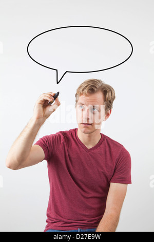 Portrait of man drawing speech bubble above his head Stock Photo