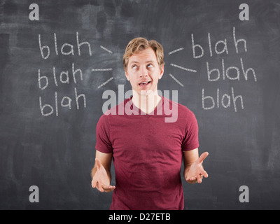 Studio shot of mid adult man with text on blackboard Stock Photo