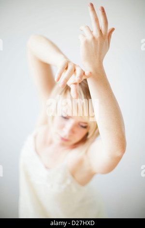 Studio shot: Happy woman with raised arms Stock Photo - Alamy