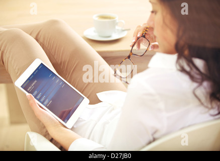 Young corporate woman checking information about her bank account online Stock Photo