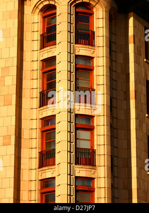 Red trimmed windows on classic old architecture Stock Photo