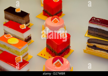 France, Alsace, Colmar. Bakery shop window in the historic city of Colmar. Detail of holiday candies and tarts. Stock Photo