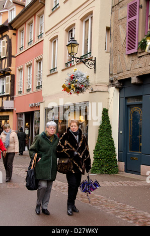 France, Alsace, Colmar. Typical street scene in historic downtown Colmar during the Christmas holiday season. Stock Photo