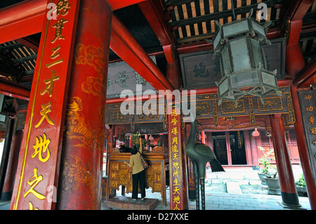Woman in a Pavilion in the Temple of Literature, a Confucius temple, Hanoi, Vietnam Stock Photo