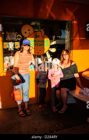 Mother children and Aunt outside a candy store on Siesta Key Island Florida Stock Photo