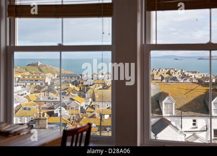 View across St Ives rooftops to 'The Island' and Carbis Bay from a holiday apartment Stock Photo