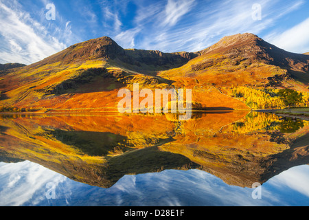 High Stile and High Crag reflected in Buttermere in the Lake District National Park.  Captured about an hour after sunrise on a Stock Photo