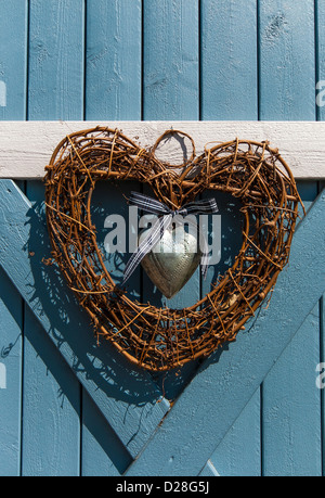 Heart shaped wreath decoration hanging on wooden door on one of the traditional wooden houses in Old Porvoo, Finland Stock Photo