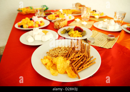 A richly set and festively decorated table with snacks Stock Photo
