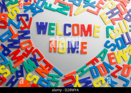 'Welcome Home' - Refrigerator magnets spell a message out of a jumble of letters Stock Photo